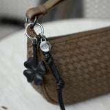 Nomi Clover Charm laukkukoriste, Black